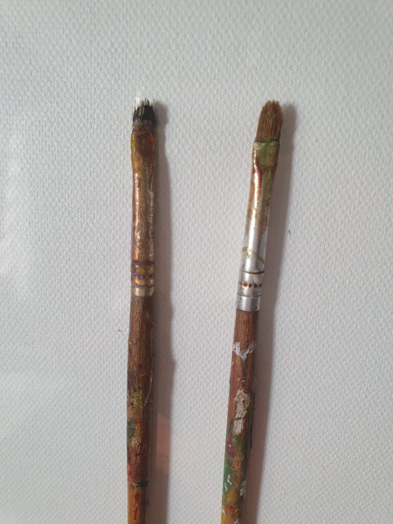 Danielle Art Original Acrylic and Oil Paintings Two used paintbrushes with paint residue on a white textured background, relevant to "My Brushes and How I take care of them.