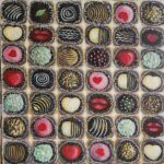 Fancy Chocolates still life painting with assorted decorative chocolates in a tray by Danielle Siauw