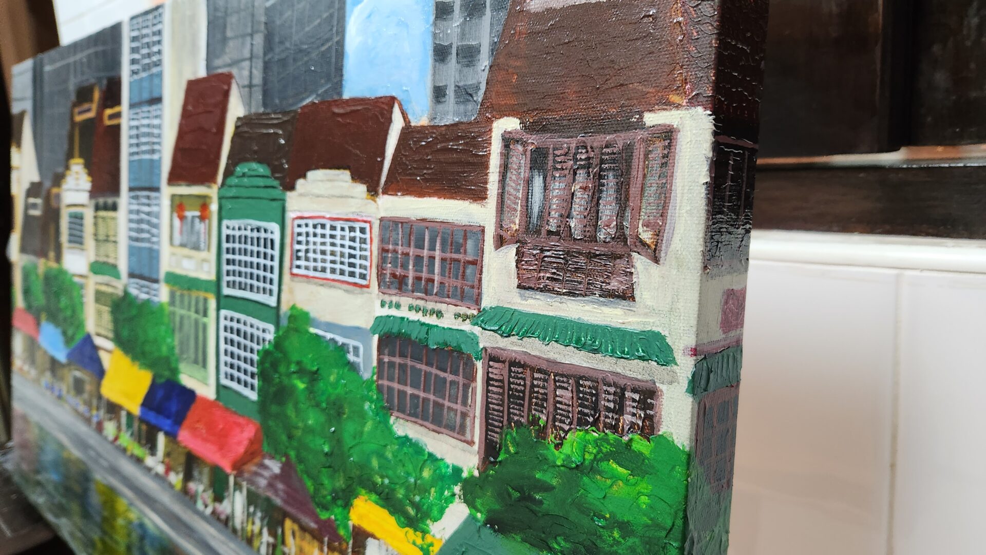 Danielle Art Original Acrylic and Oil Paintings Painting of colorful shophouses and trees along a street, "Reflections of Boat Quay