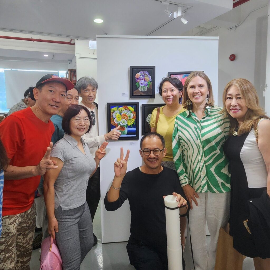 Danielle Art Original Acrylic and Oil Paintings Group of people at art exhibition with floral paintings, embracing artistic evolution