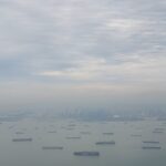 Danielle Art Original Acrylic and Oil Paintings Singapore harbor view from above with many cargo ships under a cloudy sky.