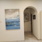 Danielle Art Original Acrylic and Oil Paintings Painting of a serene seascape with a cloudy sky in a cozy home.