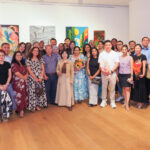 Danielle Art Original Acrylic and Oil Paintings Group photo at VOA5 Roots and Wings opening, December 3, 2025. Art exhibition attendees smiling.