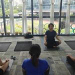 Danielle Art Original Acrylic and Oil Paintings Yoga in session: instructor guides three students in seated poses, promoting wellness and support.