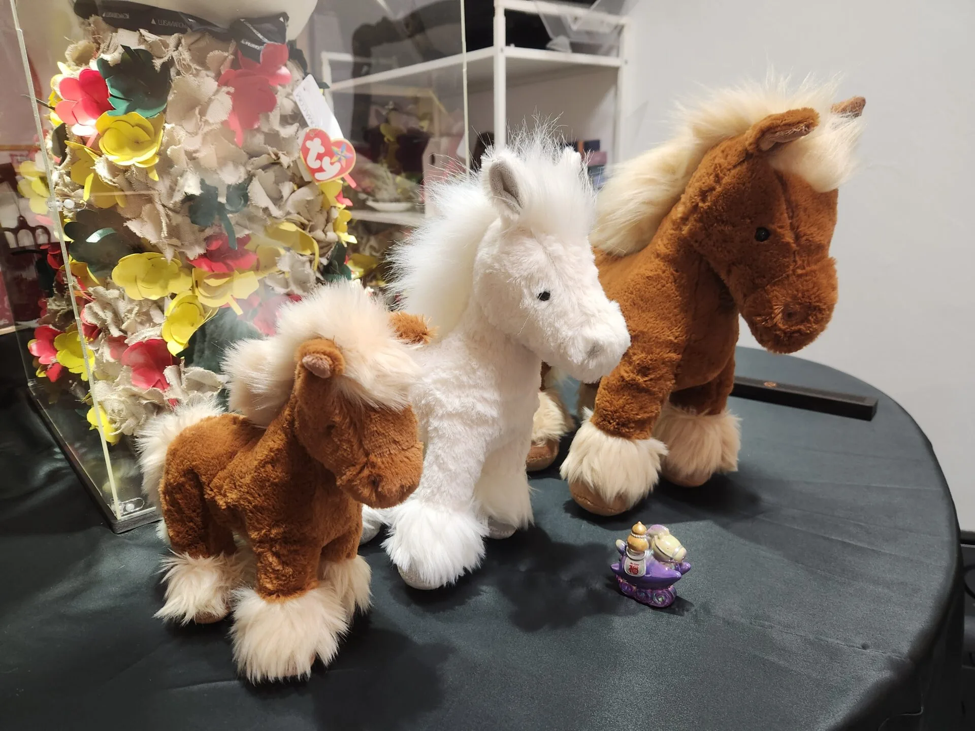 Danielle Art Original Acrylic and Oil Paintings Three plush toy horses, brown and white, with a small teapot figurine.