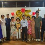 Danielle Art Original Acrylic and Oil Paintings Family celebrating 85th anniversary with balloons and a priest.
