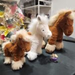 Danielle Art Original Acrylic and Oil Paintings Three plush toy horses, brown and white, with a small teapot figurine.