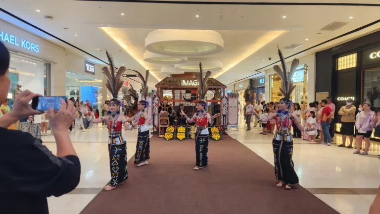 Danielle Art Original Acrylic and Oil Paintings Cultural dance performance in Kota Kinabalu mall. Performers in traditional dress on stage.