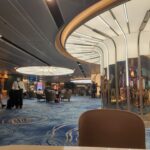 Danielle Art Original Acrylic and Oil Paintings Modern airport interior with wavy blue carpet and stylish architecture.