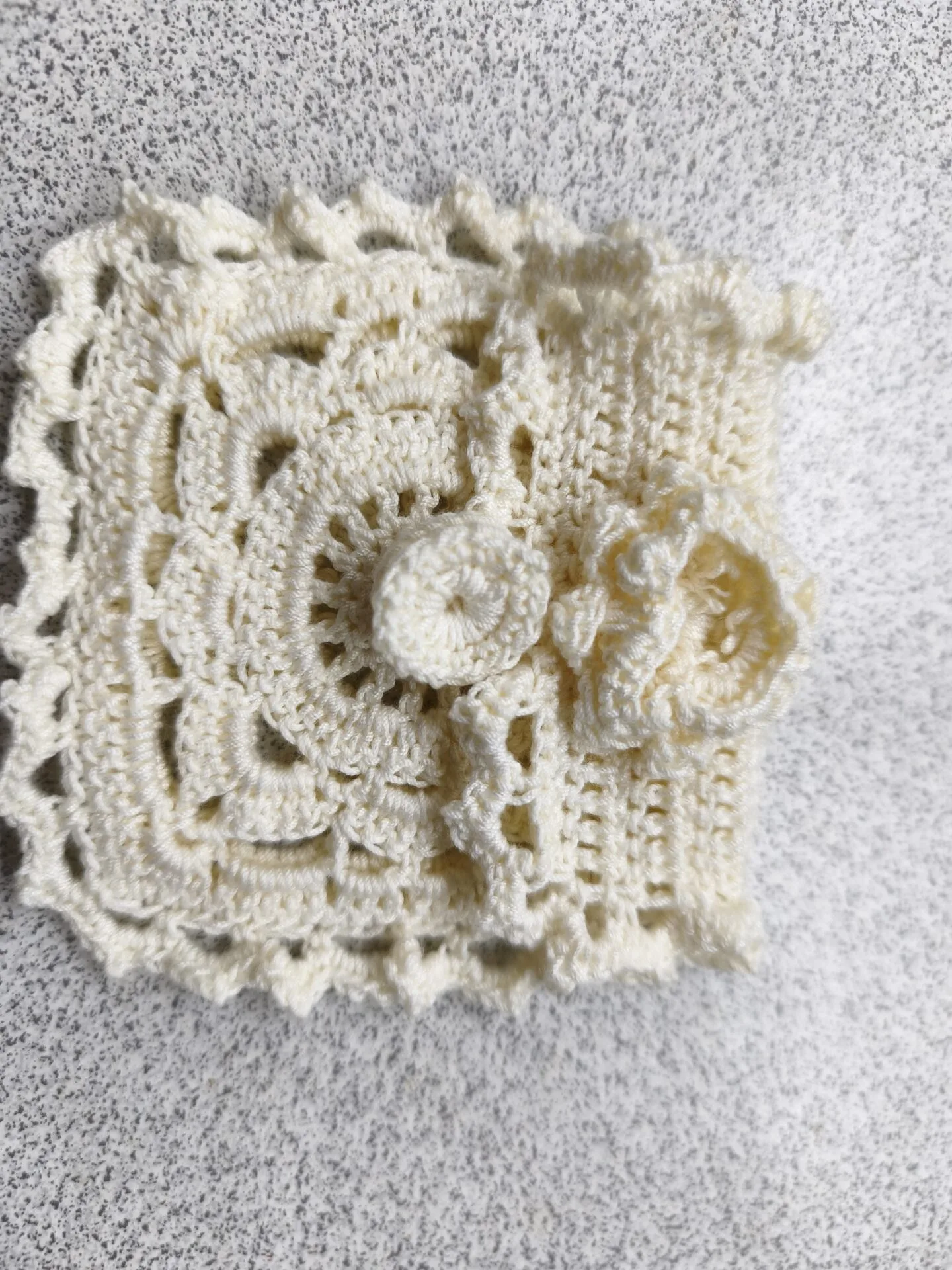 Danielle Art Original Acrylic and Oil Paintings Cream crochet doily with a circular flower embellishment on a textured surface.
